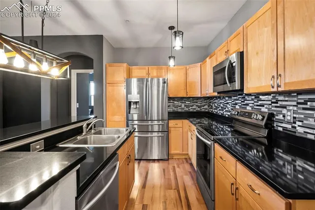 a kitchen with stainless steel appliances a stove sink and cabinets
