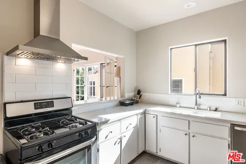 a kitchen with a stove a sink and a refrigerator