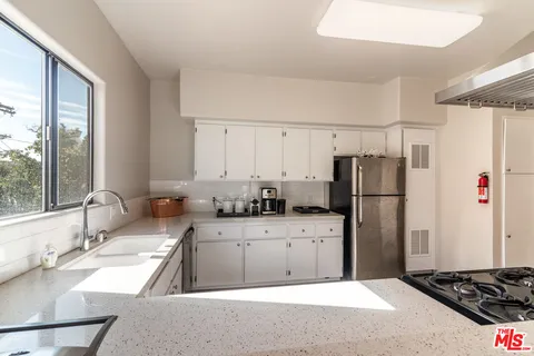 a kitchen with a refrigerator and a sink