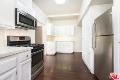 a kitchen with a refrigerator stove and microwave