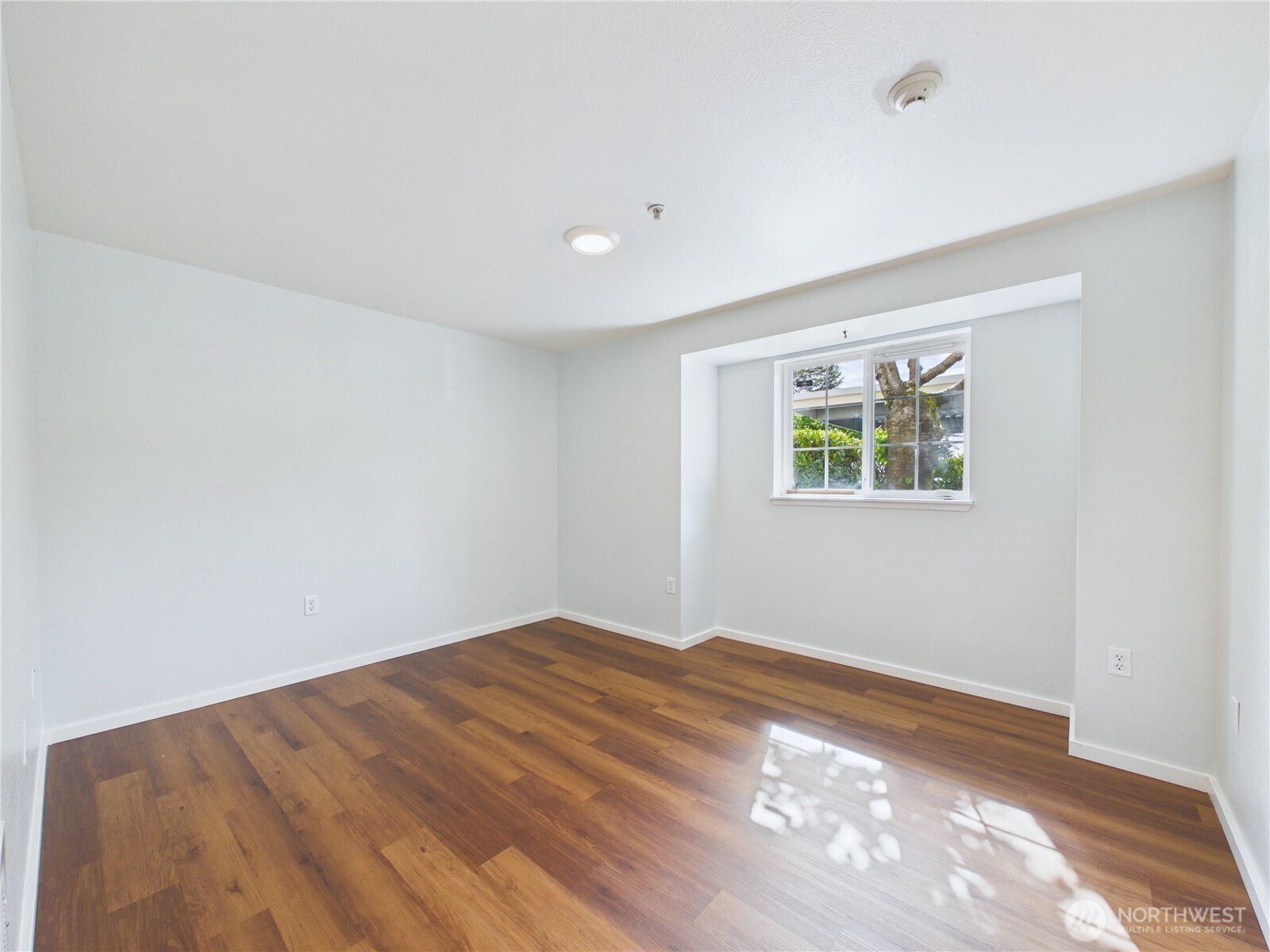 11002 Southeast Petrovitsky Road, Unit I102 Renton, WA 98055 - Photo 15 of 24 a view of empty room with wooden floor