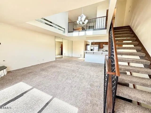 a view of a livingroom with furniture and staircase