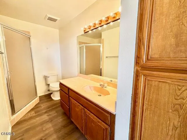 a spacious bathroom with a granite countertop sink and a mirror