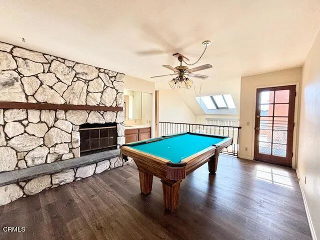 a room with pool table and windows