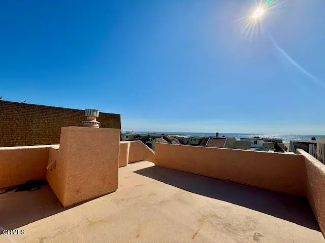 a view of a balcony with cars parked