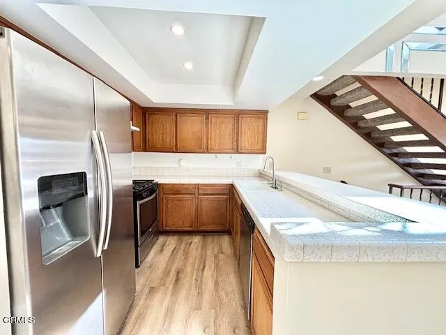 a kitchen with a sink a stove and a refrigerator