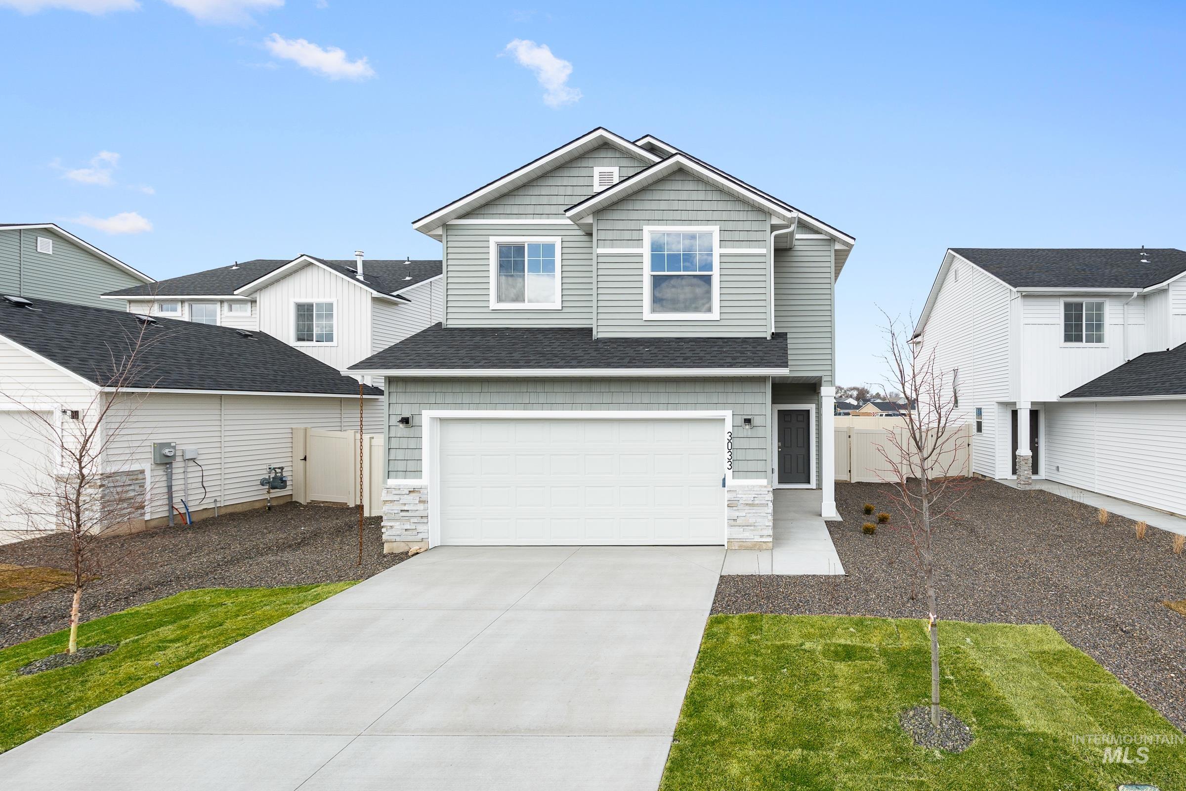 3033 South Maple Rnch Way Nampa, ID 83686 - Photo 1 of 1 View of front facade featuring concrete driveway, a garage, stone siding, and a shingled roof