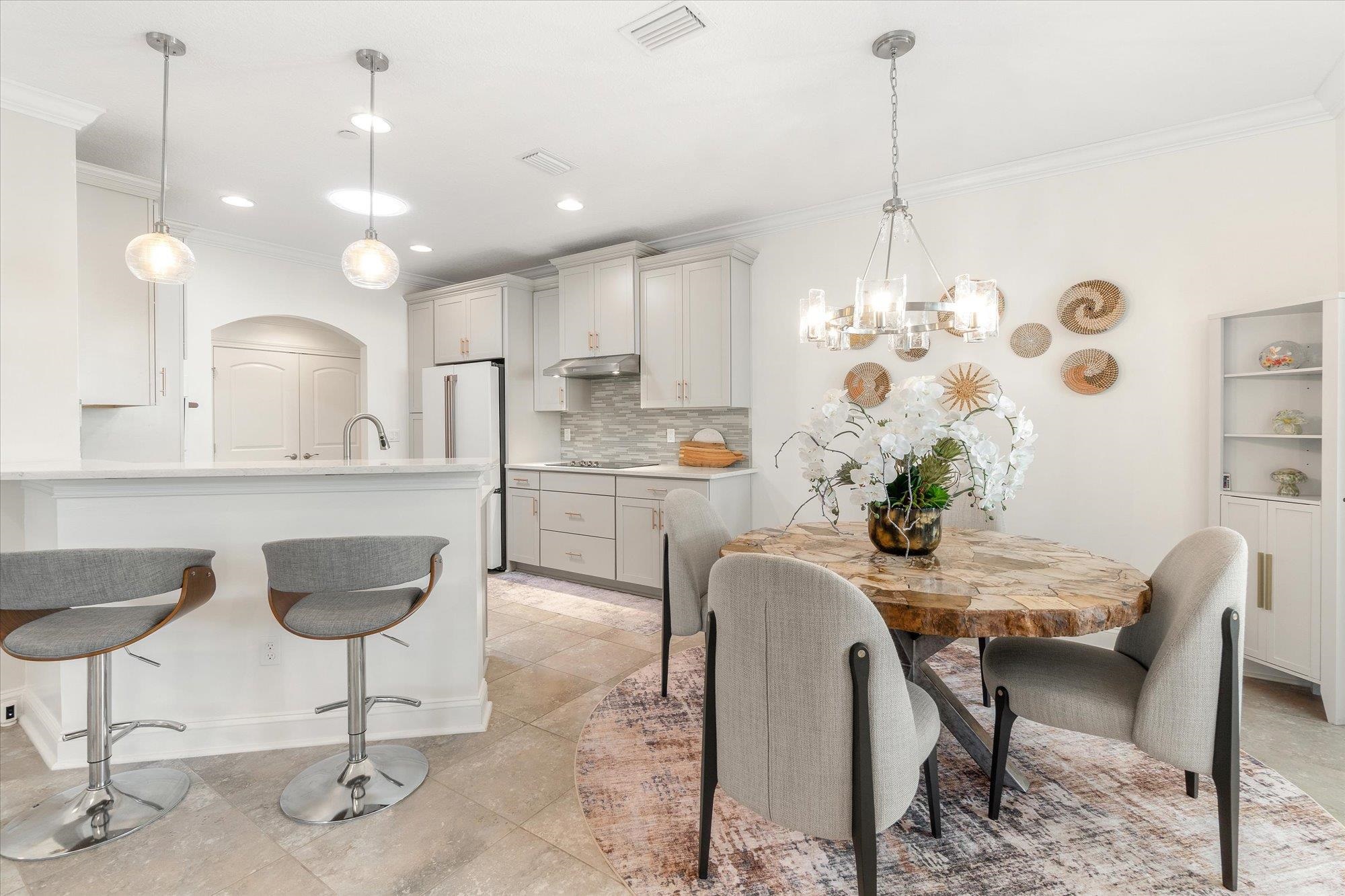 82 Timoga Trail St. Augustine, FL 32084 - Photo 11 of 62 a kitchen with kitchen island granite countertop a counter space dining table and chairs
