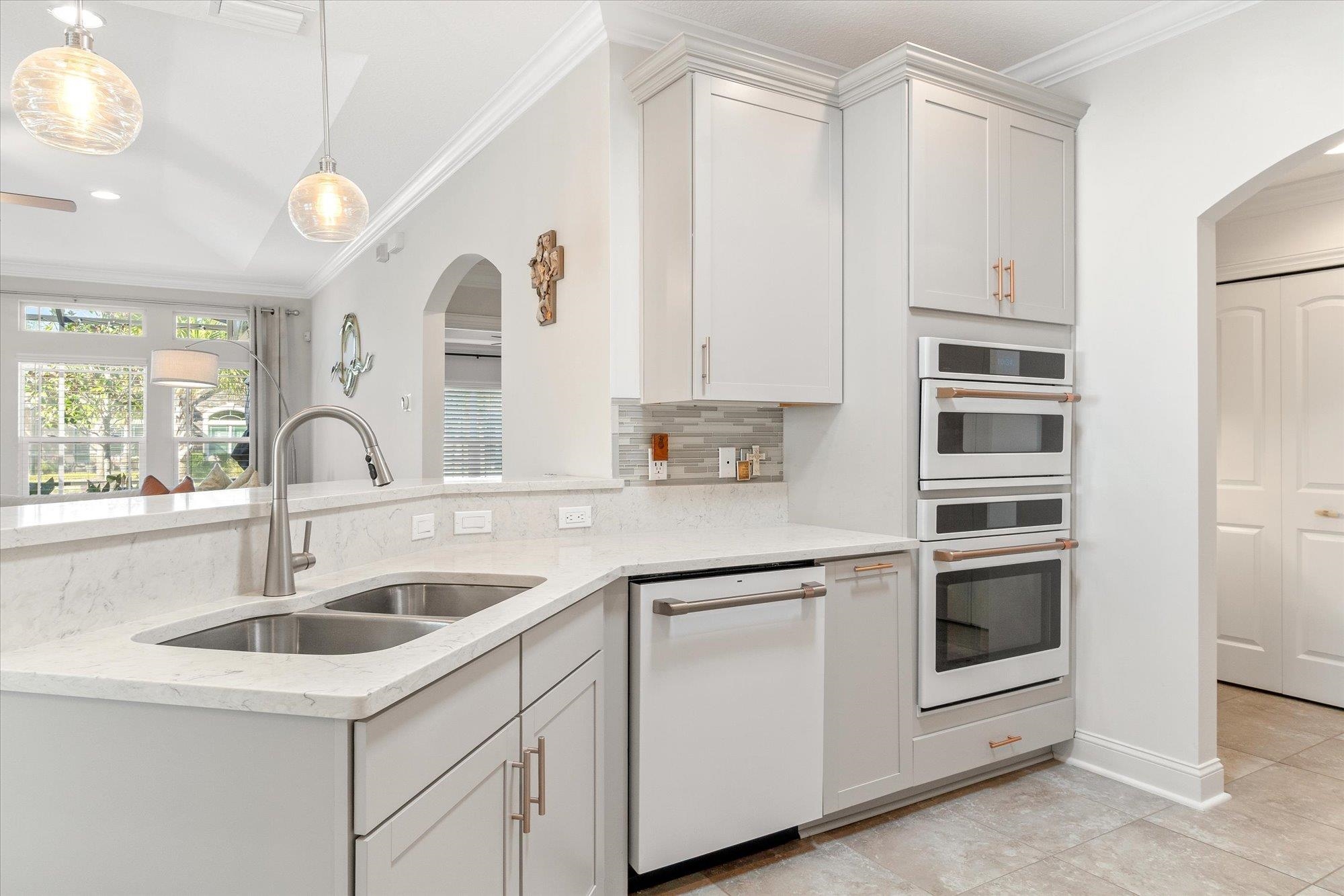 82 Timoga Trail St. Augustine, FL 32084 - Photo 13 of 62 a kitchen with white cabinets and a sink