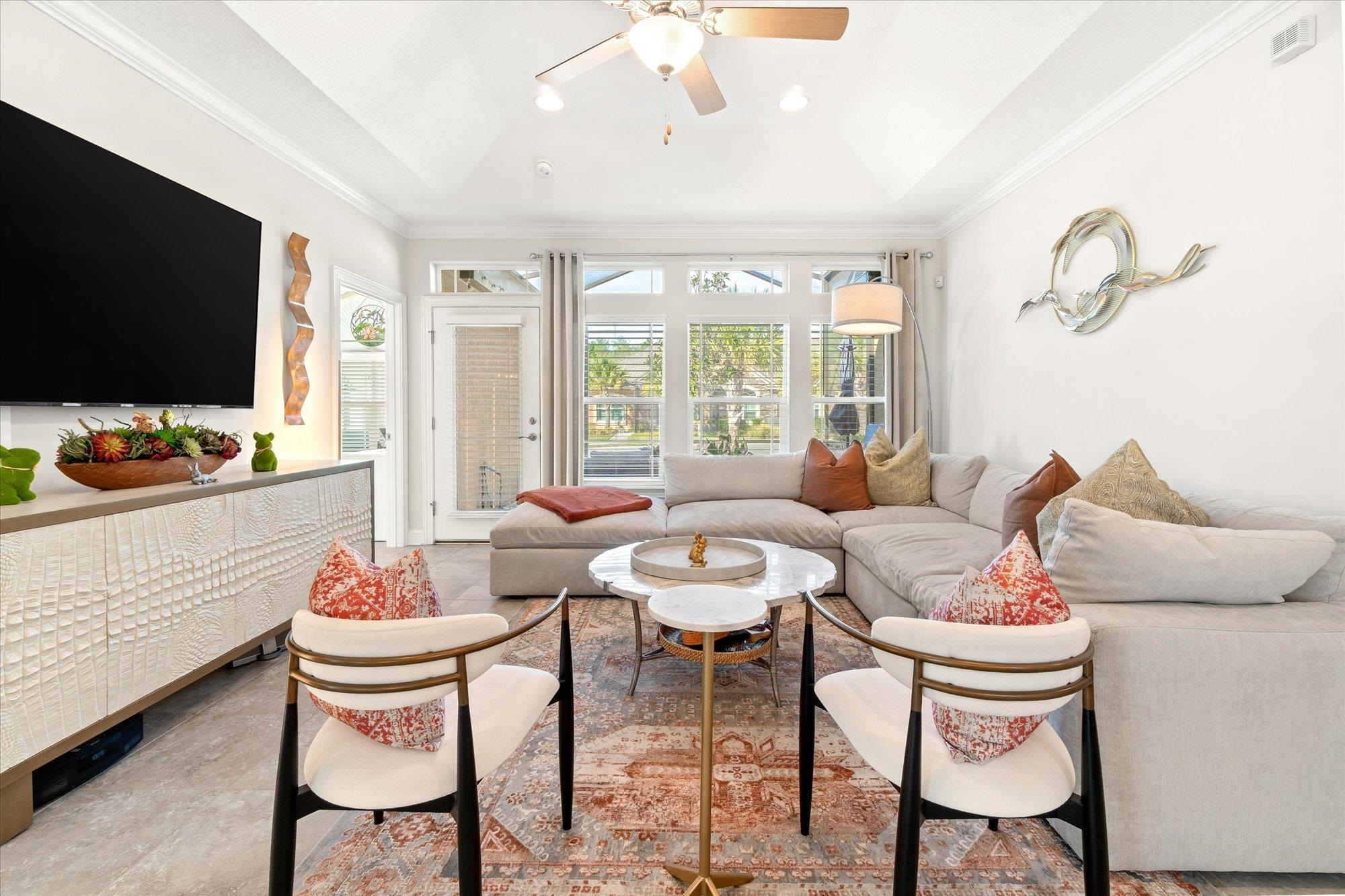 82 Timoga Trail St. Augustine, FL 32084 - Photo 16 of 62 a living room with patio furniture and a flat screen tv