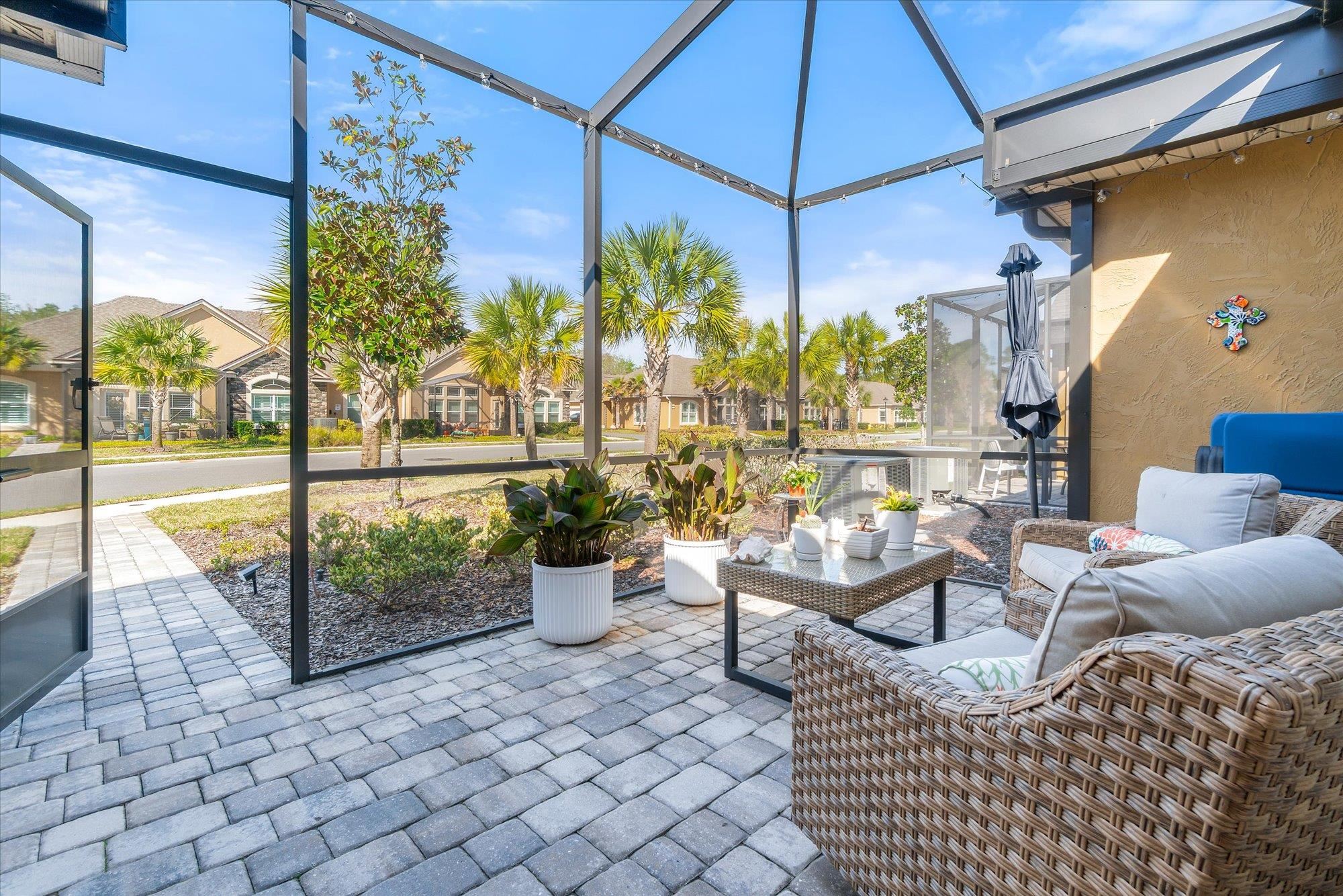 82 Timoga Trail St. Augustine, FL 32084 - Photo 35 of 62 Sunroom / solarium featuring a patio area, outdoor seating, plenty of natural light, and a residential view