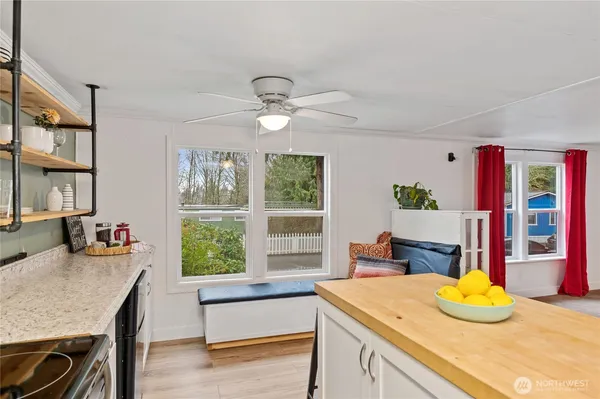 a kitchen with a table chairs and a large window