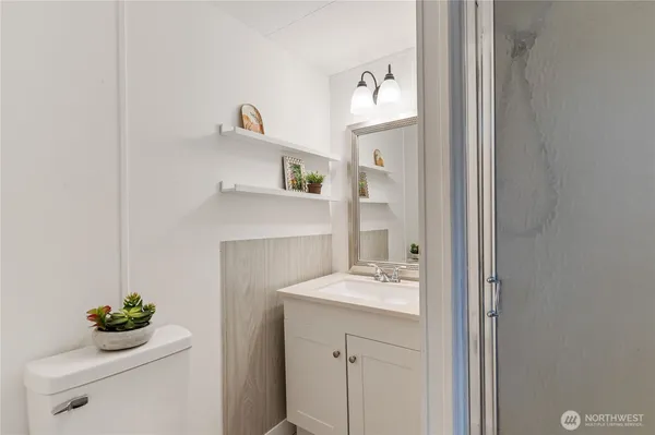 a bathroom with a sink vanity and a mirror