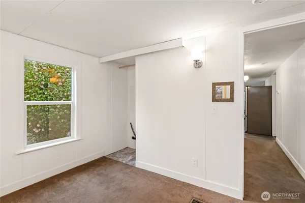 an empty room with windows and closet
