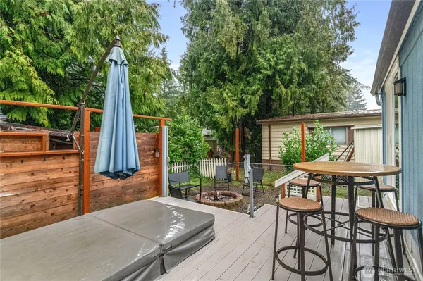 a view of backyard with outdoor seating and plants
