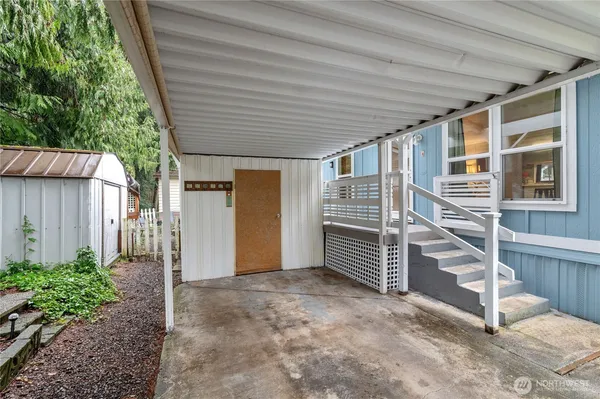 a view of house with stairs and wooden fence
