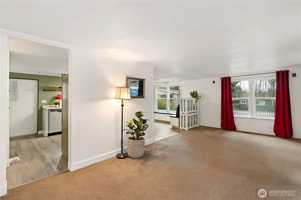 an empty room with furniture and a window