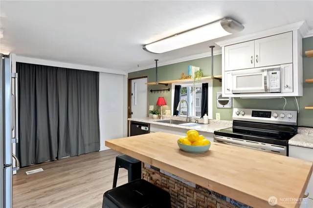 a kitchen with a table chairs and a refrigerator