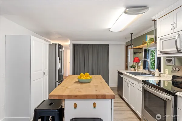 a open kitchen with stainless steel appliances granite countertop a sink stove and refrigerator