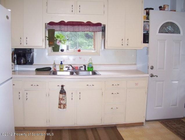 131 Mowry Road Meshoppen, PA 18630 - Photo 6 of 21 a kitchen with white cabinets and window