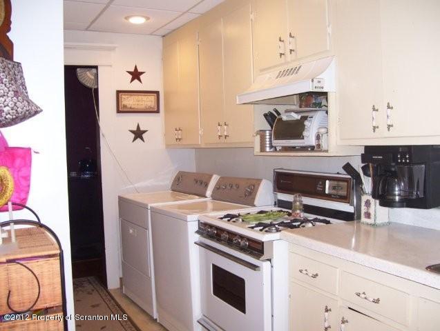 131 Mowry Road Meshoppen, PA 18630 - Photo 8 of 21 a kitchen with stainless steel appliances granite countertop a stove and a refrigerator