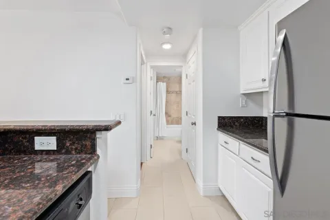 a kitchen with stainless steel appliances granite countertop a stove and a refrigerator