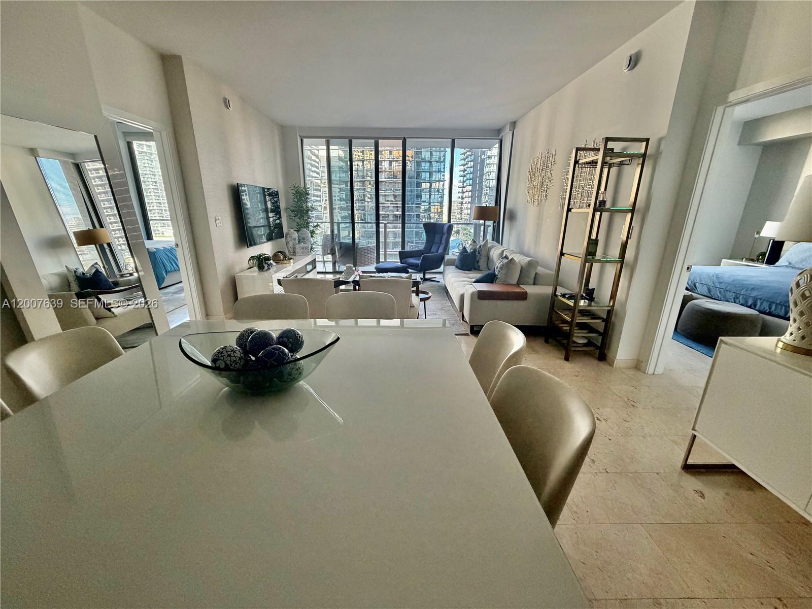 88 Southwest 7th Street, Unit 1109 Miami, FL 33130 - Photo 11 of 40 a living room with furniture and a large window