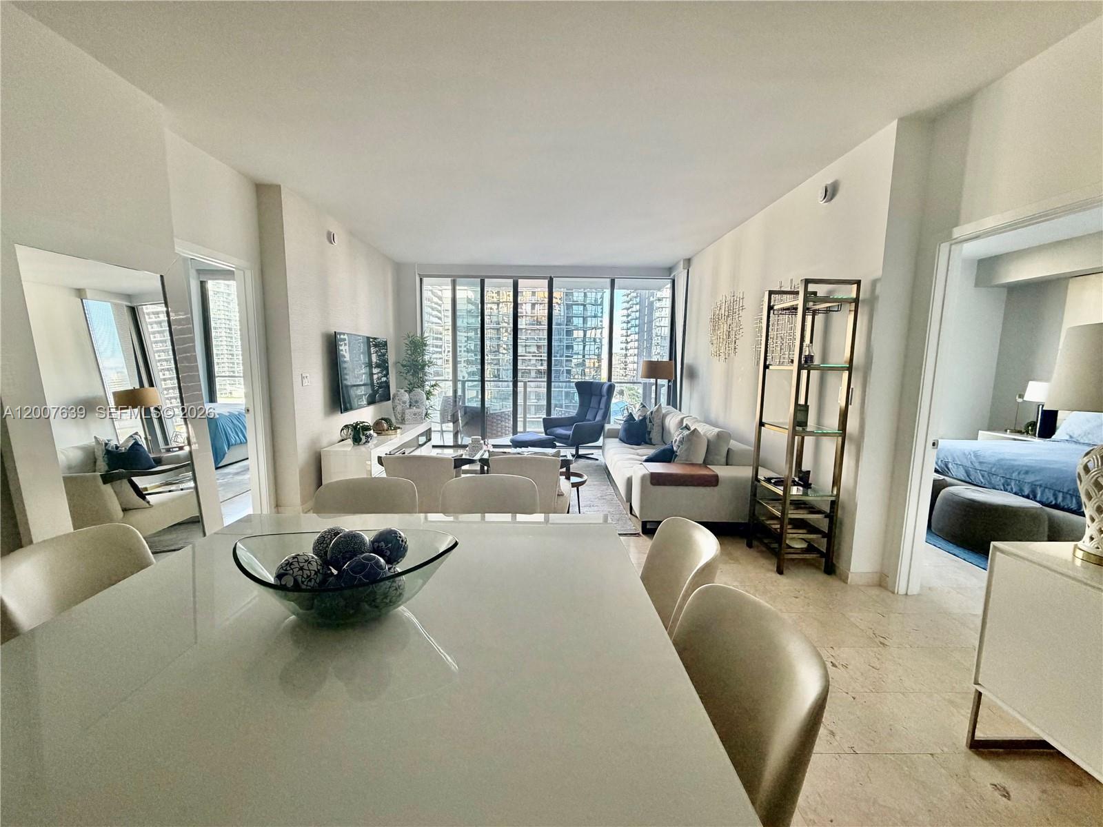 88 Southwest 7th Street, Unit 1109 Miami, FL 33130 - Photo 12 of 40 a living room with furniture and a large window