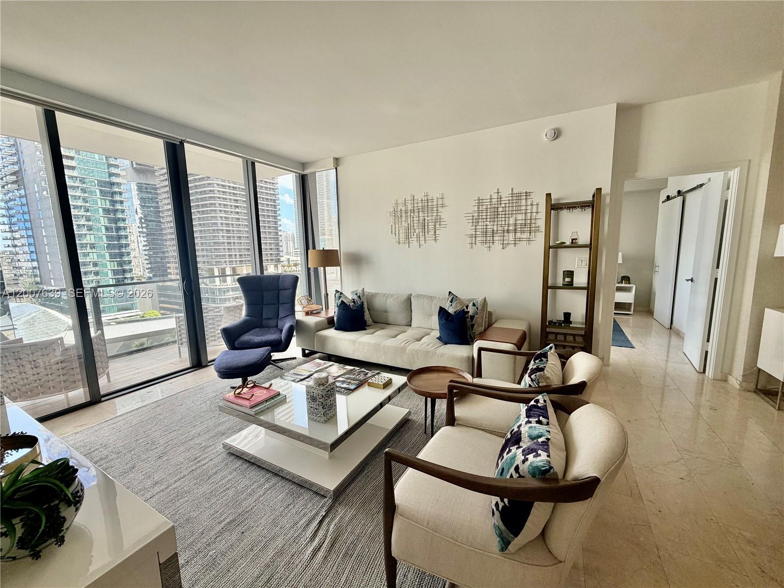 88 Southwest 7th Street, Unit 1109 Miami, FL 33130 - Photo 18 of 40 a living room with furniture and a floor to ceiling window