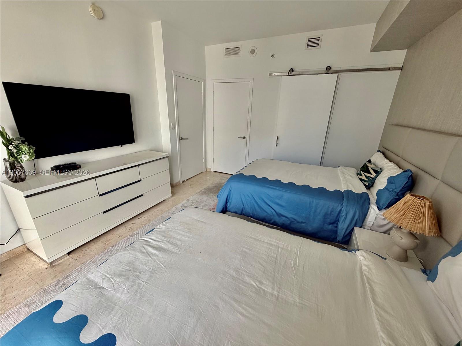 88 Southwest 7th Street, Unit 1109 Miami, FL 33130 - Photo 20 of 40 a bedroom with a bed and a flat screen tv