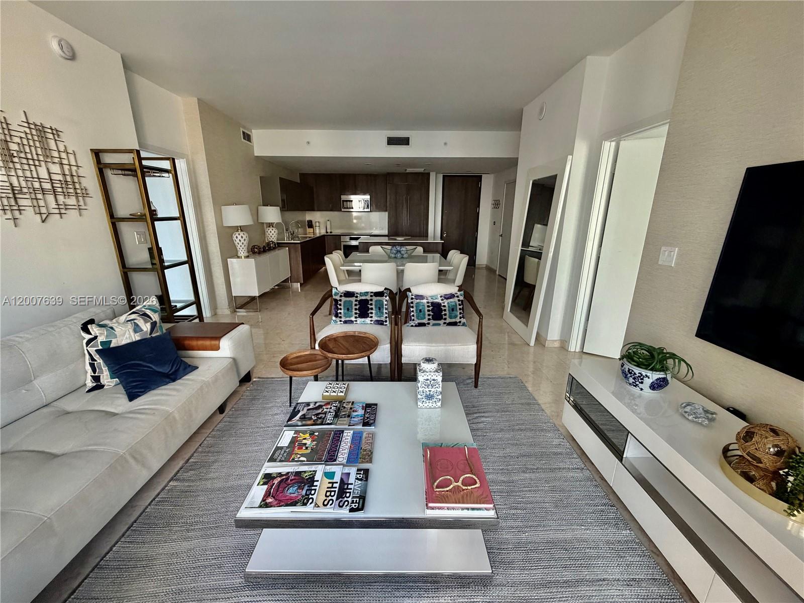 88 Southwest 7th Street, Unit 1109 Miami, FL 33130 - Photo 2 of 40 a living room with furniture and a flat screen tv