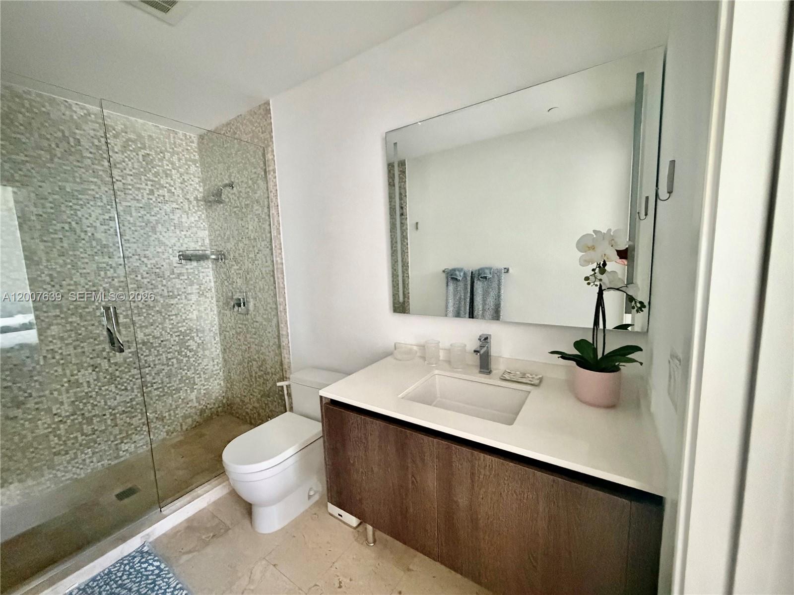 88 Southwest 7th Street, Unit 1109 Miami, FL 33130 - Photo 22 of 40 a bathroom with a sink and toilet