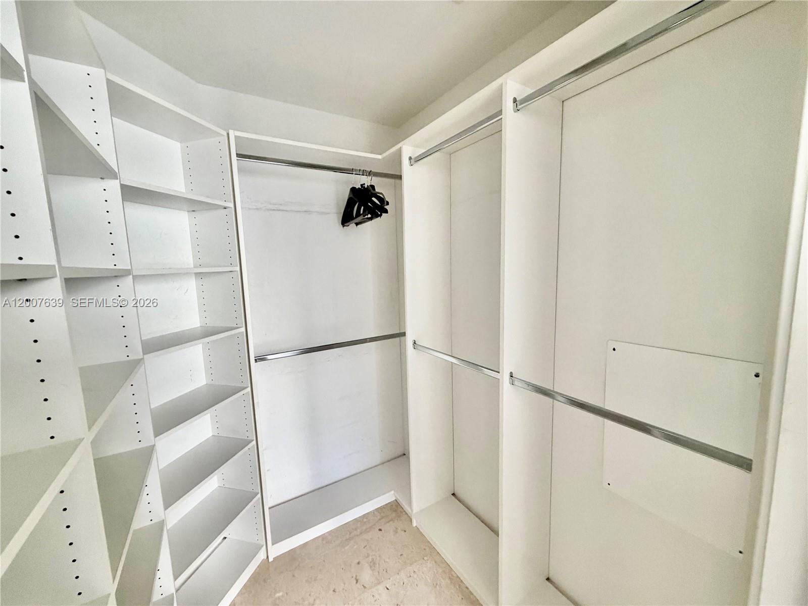 88 Southwest 7th Street, Unit 1109 Miami, FL 33130 - Photo 23 of 40 a view of walk in closet with empty racks