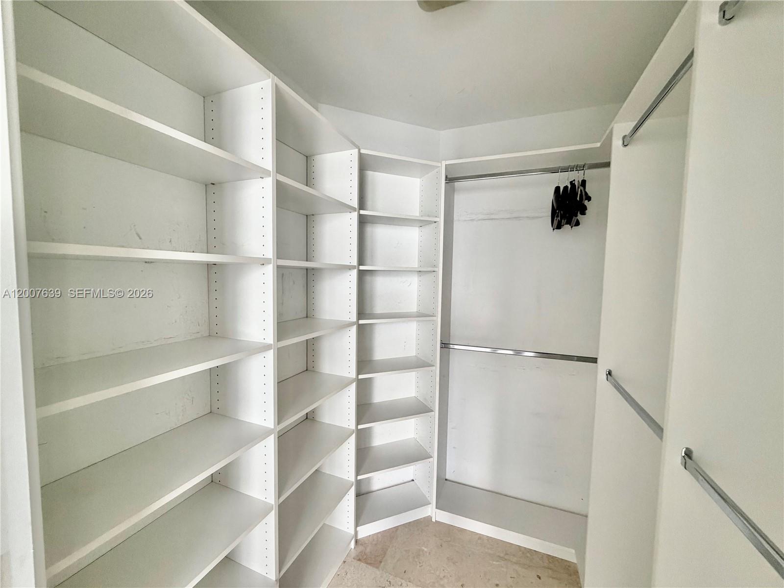 88 Southwest 7th Street, Unit 1109 Miami, FL 33130 - Photo 24 of 40 a view of walk in closet with empty racks