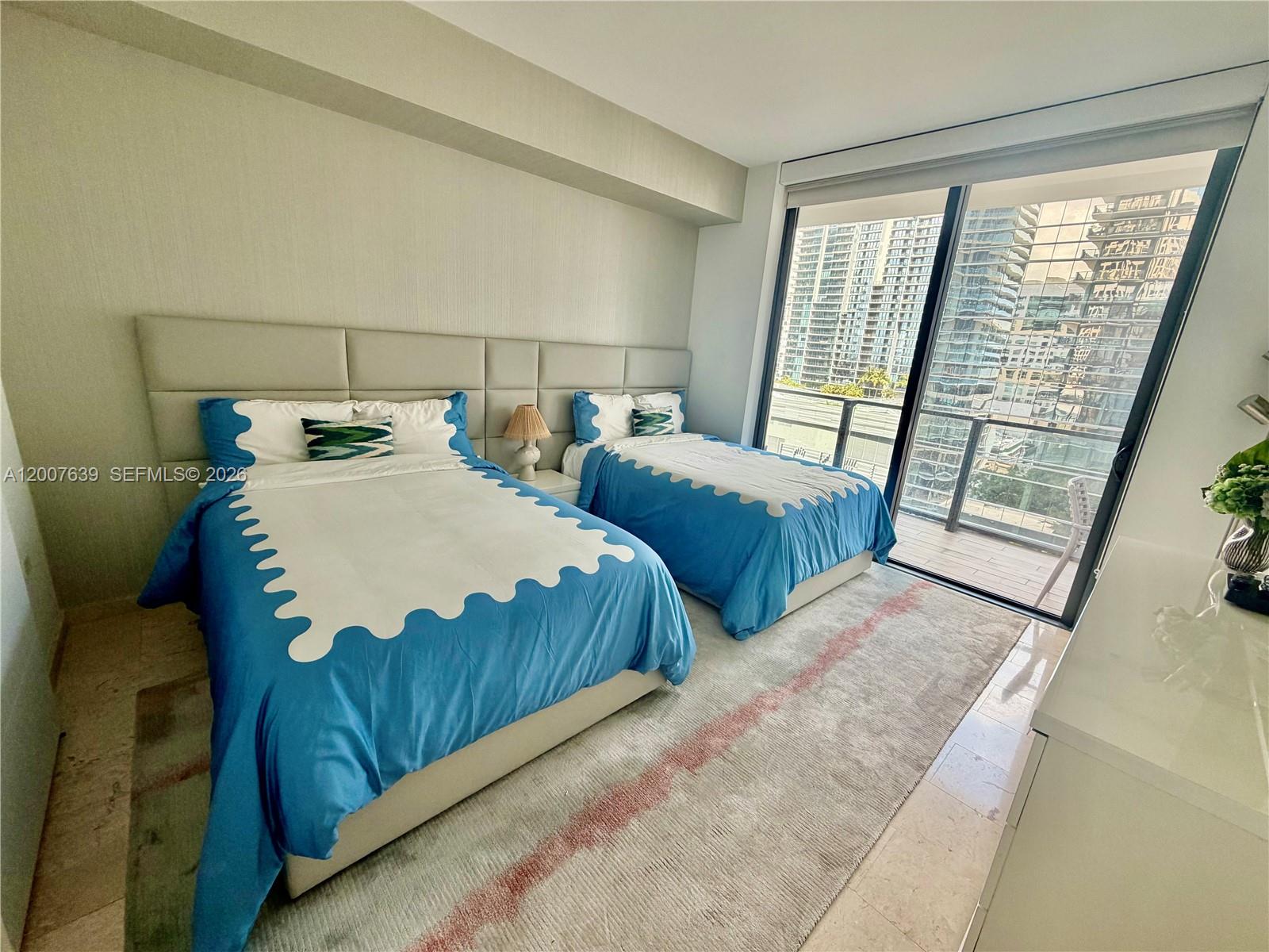 88 Southwest 7th Street, Unit 1109 Miami, FL 33130 - Photo 25 of 40 a bedroom with two beds and a large window