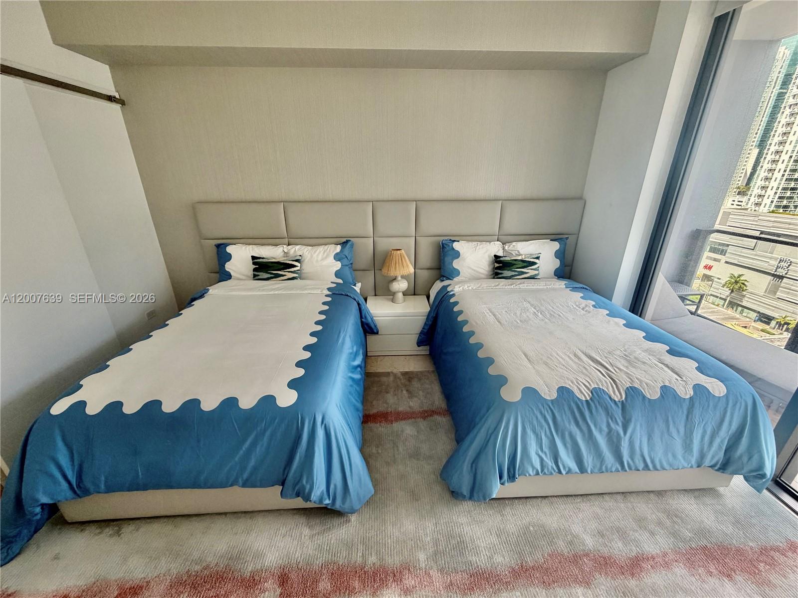 88 Southwest 7th Street, Unit 1109 Miami, FL 33130 - Photo 26 of 40 a bedroom with a bed and window