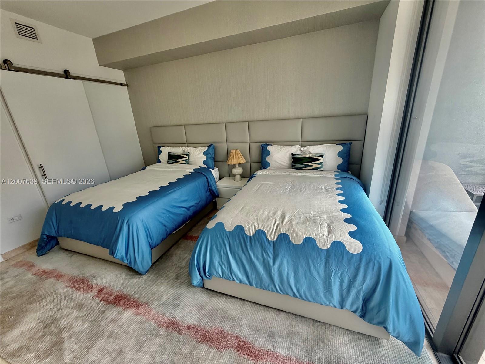 88 Southwest 7th Street, Unit 1109 Miami, FL 33130 - Photo 27 of 40 a bedroom with a bed and a mirror