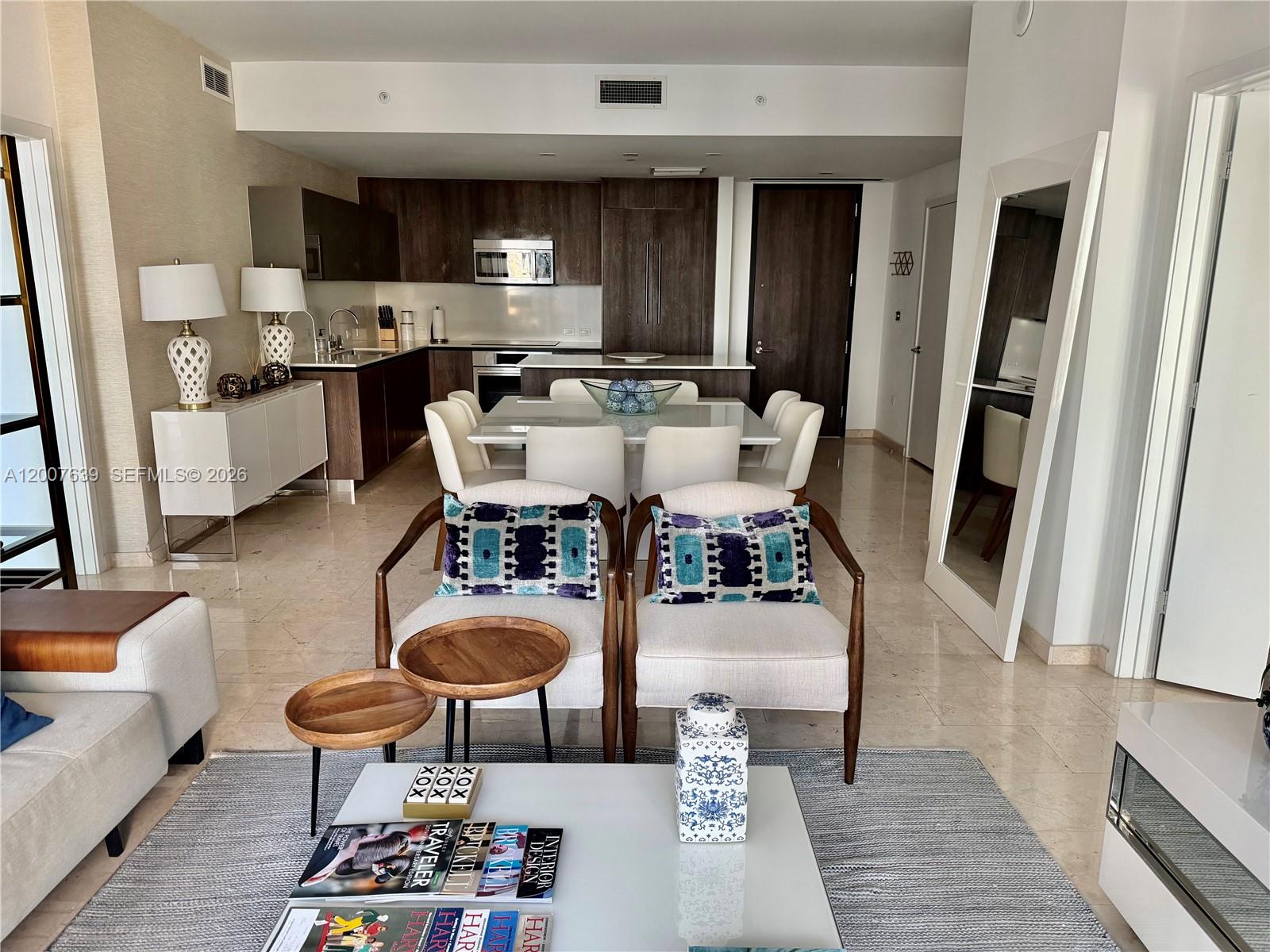 88 Southwest 7th Street, Unit 1109 Miami, FL 33130 - Photo 3 of 40 a living room with stainless steel appliances furniture a rug and a view of kitchen
