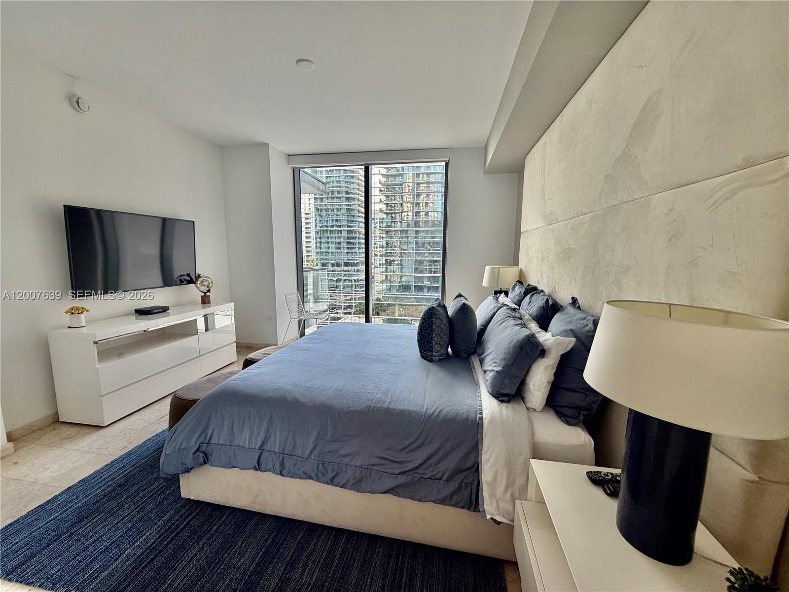 88 Southwest 7th Street, Unit 1109 Miami, FL 33130 - Photo 33 of 40 a bedroom with a bed and a flat screen tv