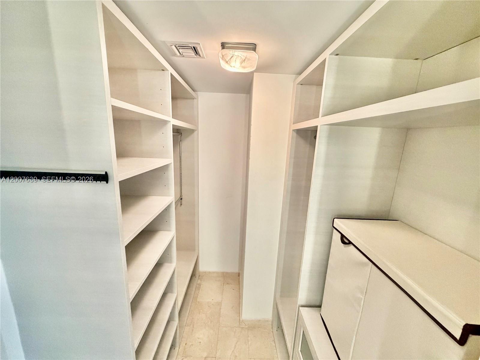 88 Southwest 7th Street, Unit 1109 Miami, FL 33130 - Photo 35 of 40 a view of walk in closet with empty racks
