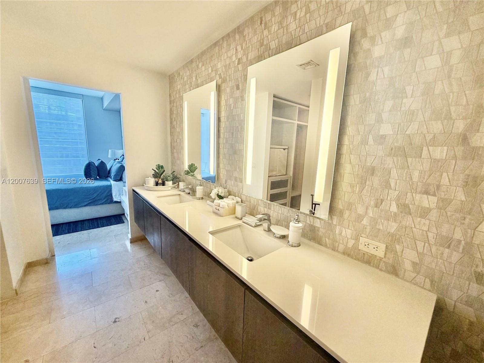 88 Southwest 7th Street, Unit 1109 Miami, FL 33130 - Photo 36 of 40 a bathroom with a double vanity sink and a bathtub