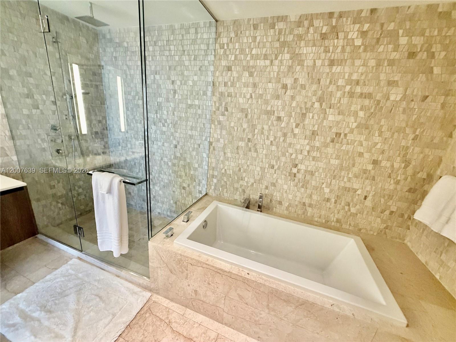 88 Southwest 7th Street, Unit 1109 Miami, FL 33130 - Photo 37 of 40 a bathroom with a bathtub and shower