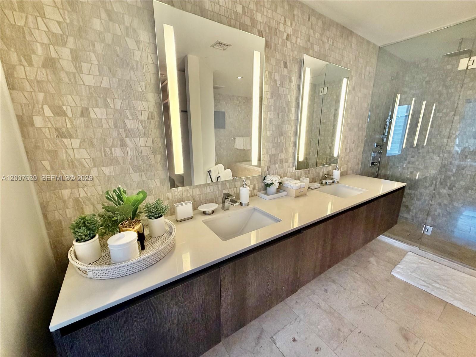 88 Southwest 7th Street, Unit 1109 Miami, FL 33130 - Photo 39 of 40 a bathroom with a sink double vanity and a mirror