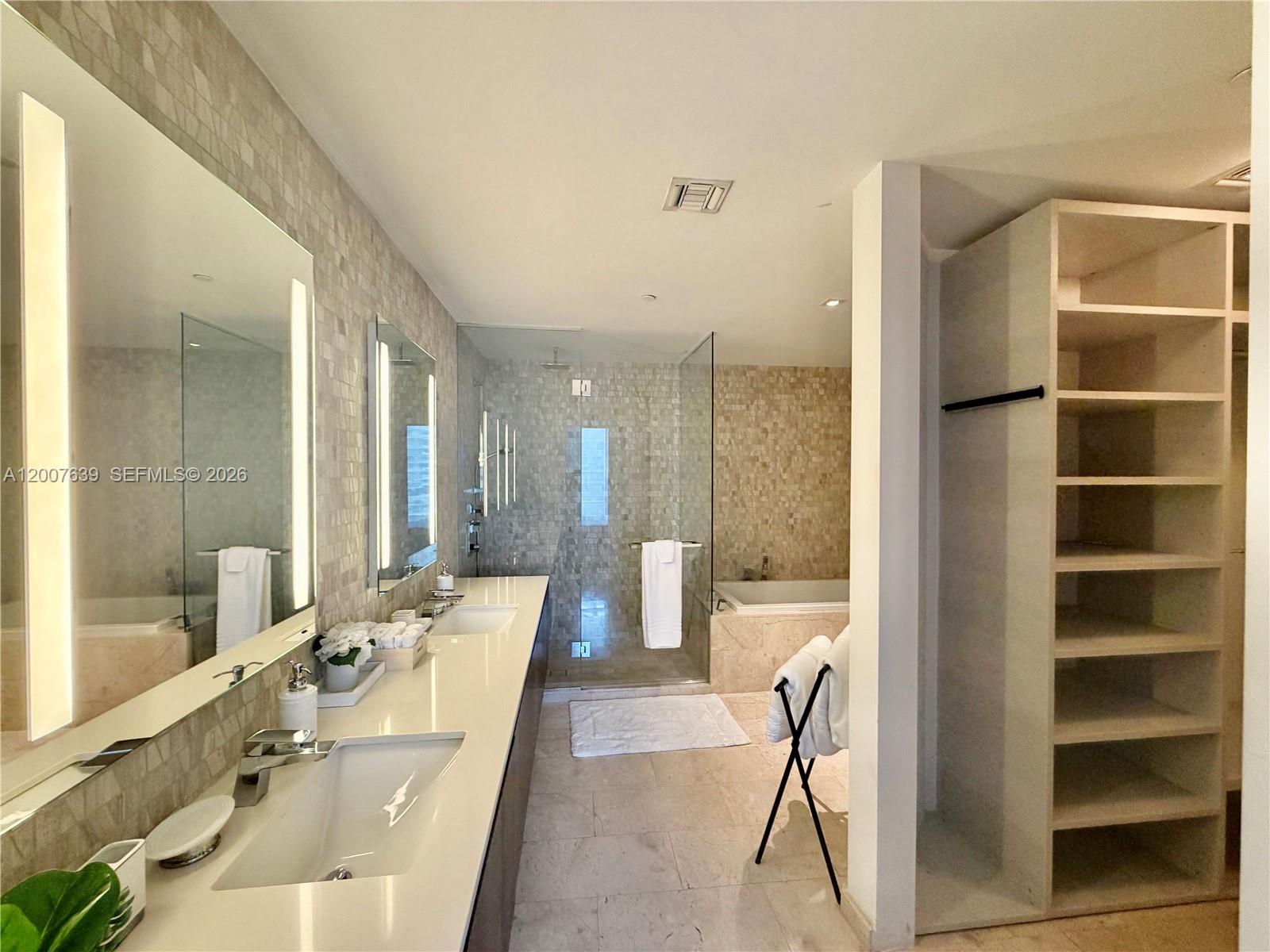 88 Southwest 7th Street, Unit 1109 Miami, FL 33130 - Photo 40 of 40 a large bathroom with a large tub and sink