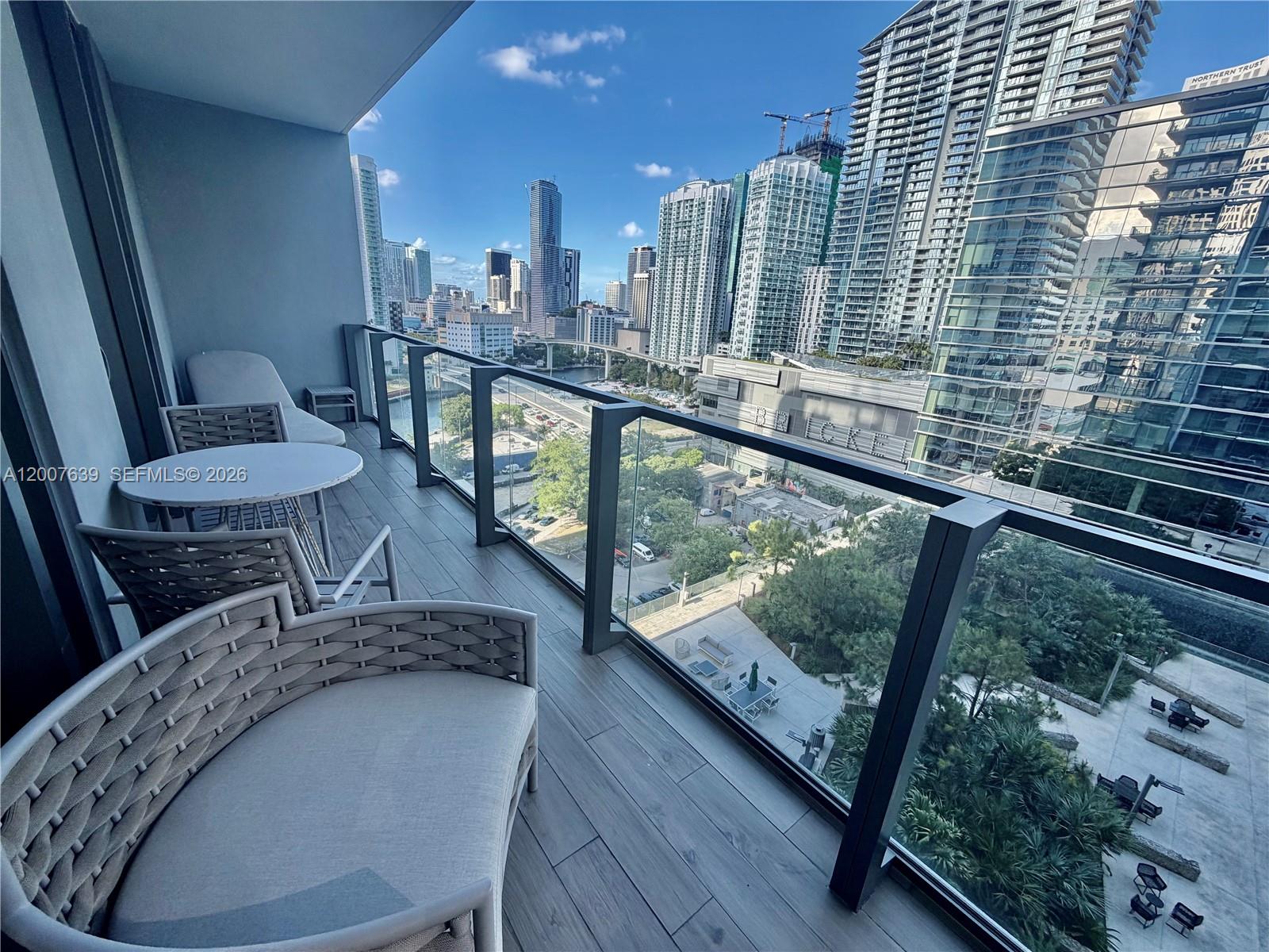 88 Southwest 7th Street, Unit 1109 Miami, FL 33130 - Photo 7 of 40 a view of a balcony with chairs