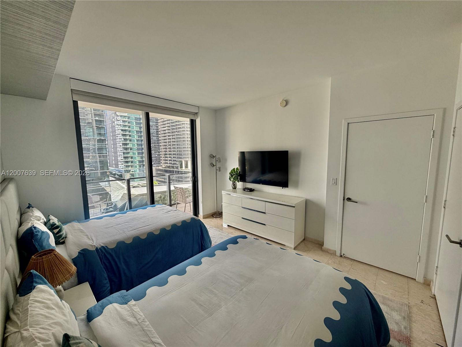 88 Southwest 7th Street, Unit 1109 Miami, FL 33130 - Photo 8 of 40 a bedroom with a bed and a flat screen tv