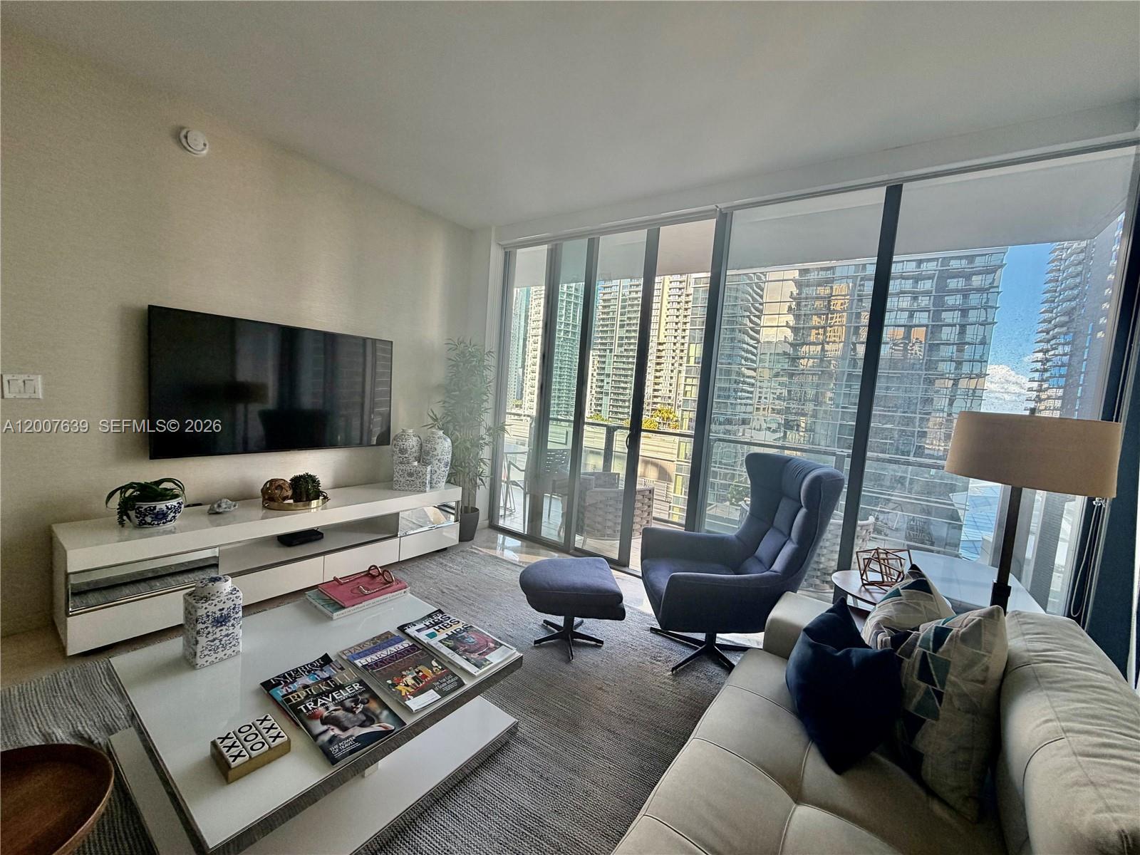 88 Southwest 7th Street, Unit 1109 Miami, FL 33130 - Photo 9 of 40 a living room with furniture and a flat screen tv