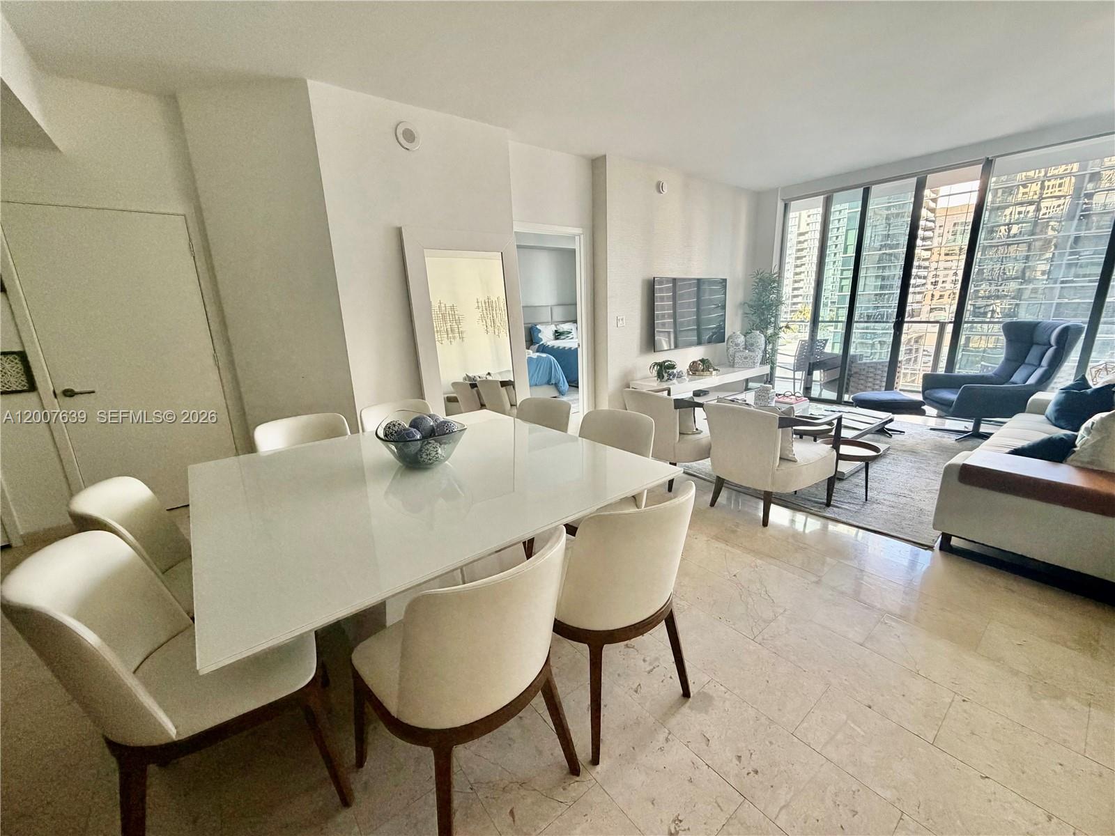 88 Southwest 7th Street, Unit 1109 Miami, FL 33130 - Photo 10 of 40 a view of a dining room with furniture window and outside view