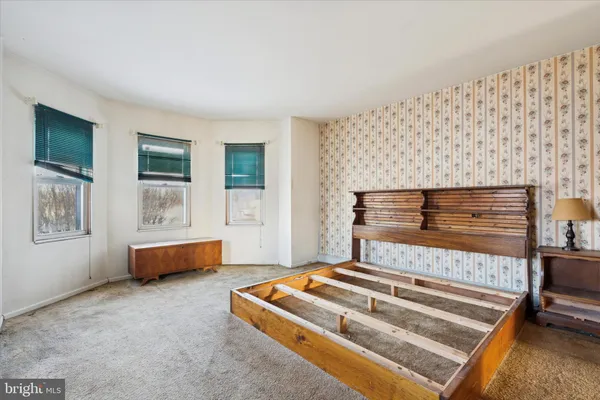 a bedroom with bed and window