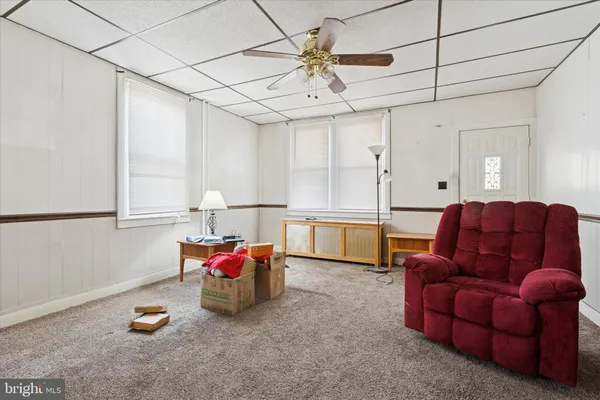 a living room with furniture and kitchen view